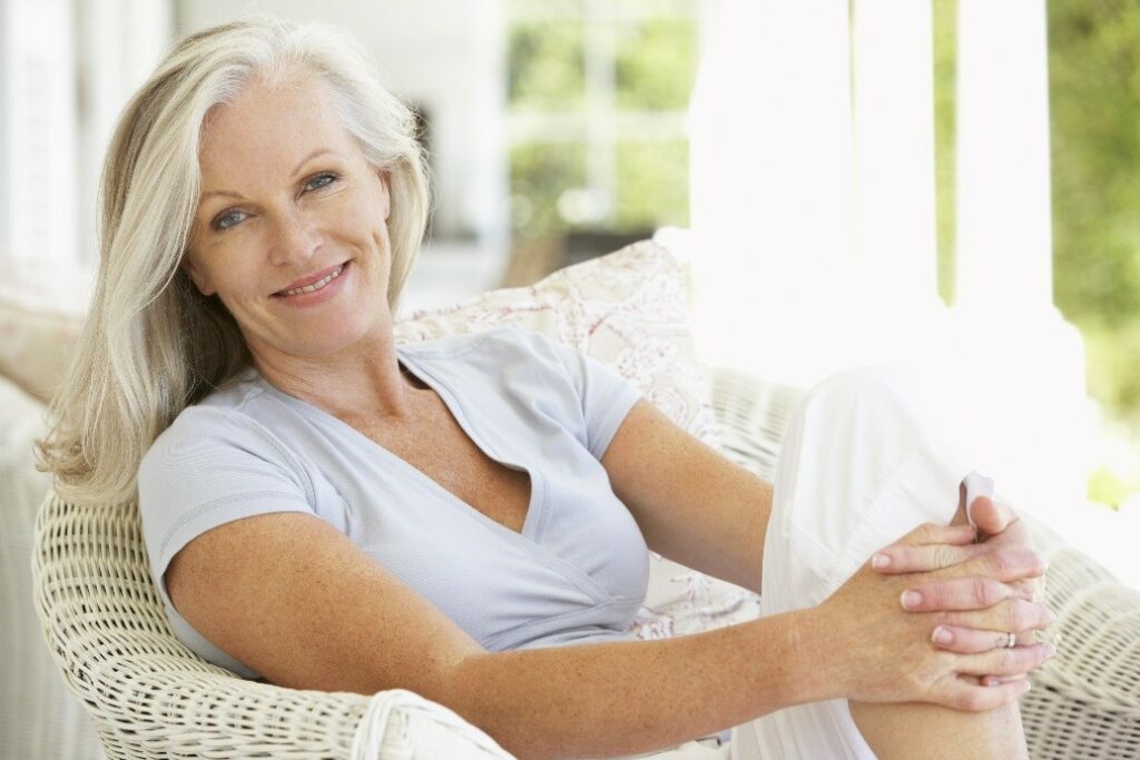 Older woman smiling after skin therapy.