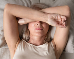 woman laying in bed who can't sleep