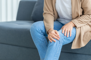 Woman with osteoarthritis holding knee
